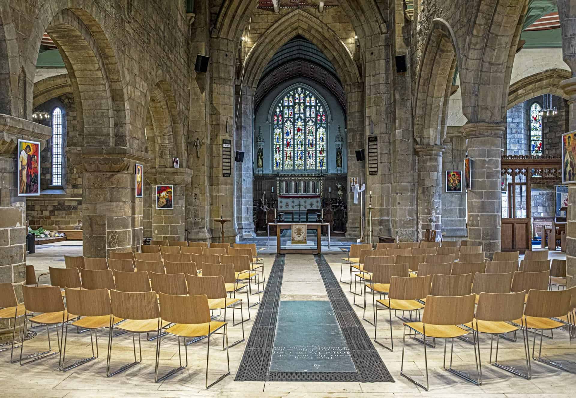 Wooden and metal stacking chairs in church nave 